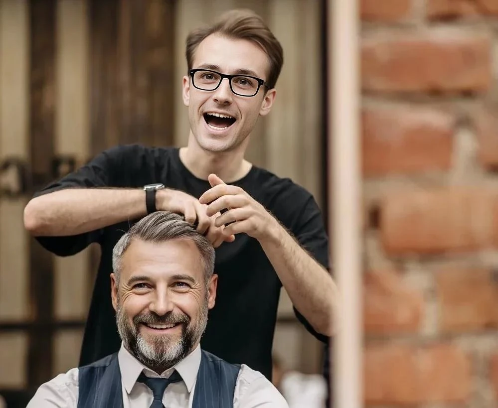 A man is getting his hair combed by another man. Generative face fill.