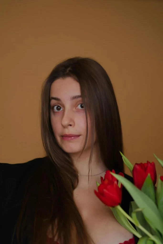 Fearful image of a young girl holding flowers