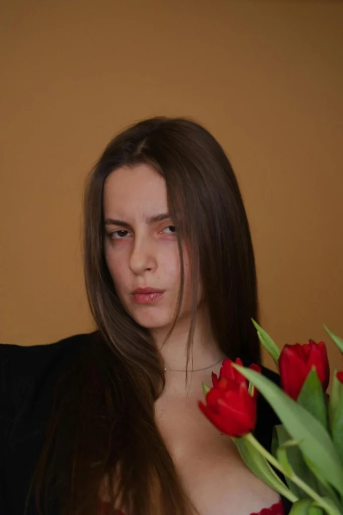 Suspicious image of a young girl holding flowers